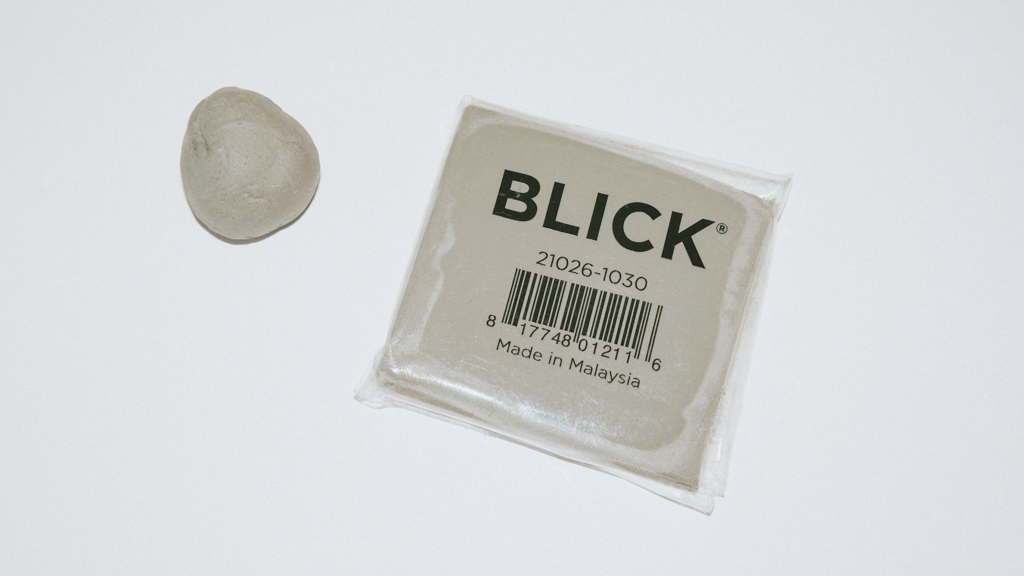 BLICK's kneaded eraser. Rolled up on the left and unopened on the right.