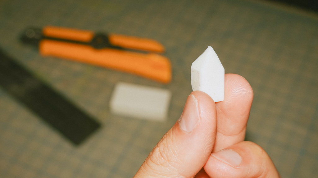 closeup of hand holding up a cut eraser.